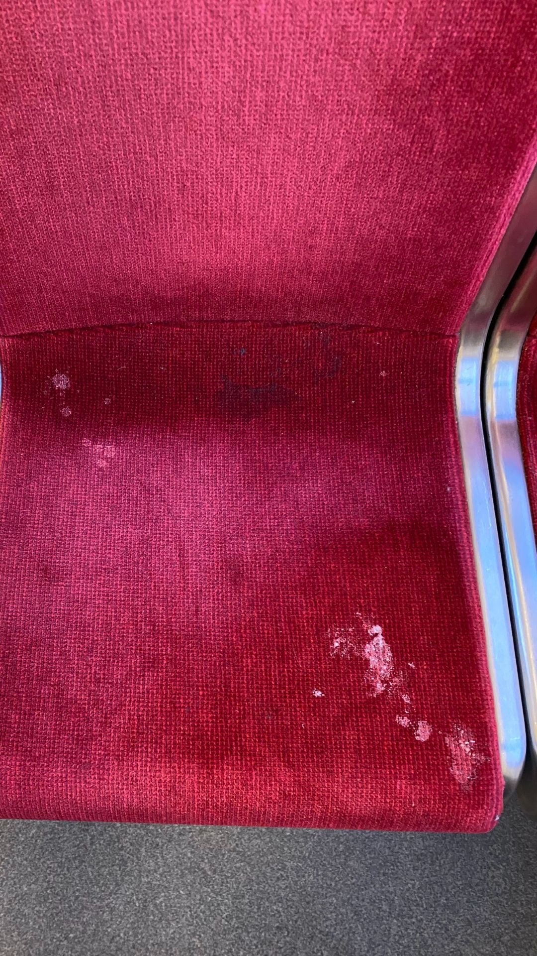 Showing a gross subway seat soiled with dirt and an unknown substance