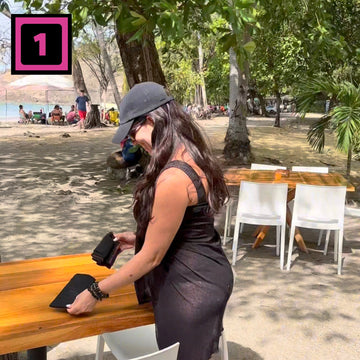 Seat Square | Picture of woman on beach at a restaurant table taking Seat Square out of pouch (to use)